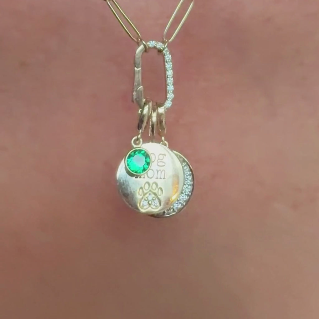 Paw print charm dangling with other gemstone and diamond versions on a pave charm holder necklace on model video, by Camille Jewelry