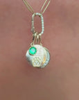Paw print charm dangling with other gemstone and diamond versions on a pave charm holder necklace on model video, by Camille Jewelry