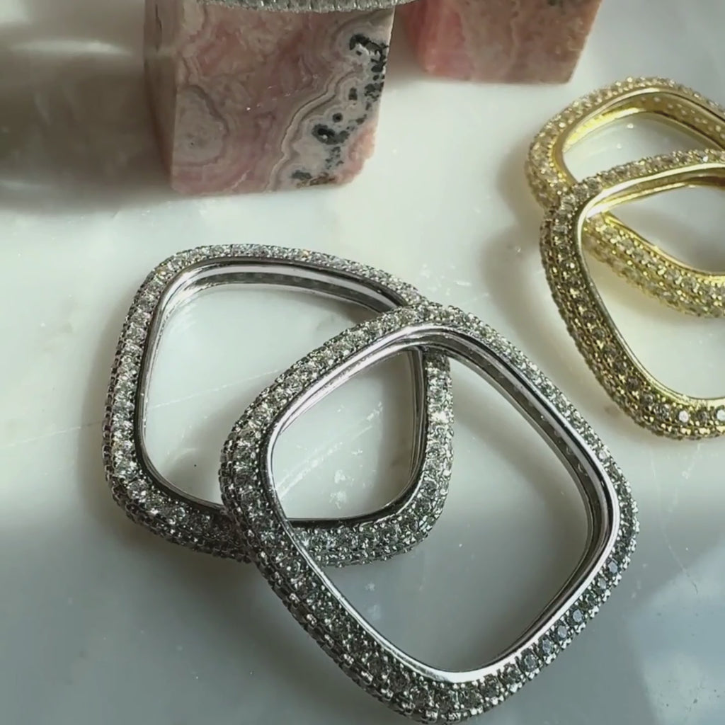 video of pave square rings in rhodium plated and gold plated sterling silver on a quartz display for Camille Jewelry
