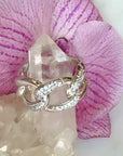 Large Pave curb chain ring on a quartz stone and orchid flower video | Camille Jewelry