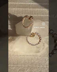 Lab Diamond Loop Hoop Earrings on display on a quartz stone and on model from Camille Jewelry.