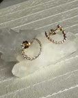 Graduated lab created small Diamond hoop earrings on a leather display for Camille Jewelry