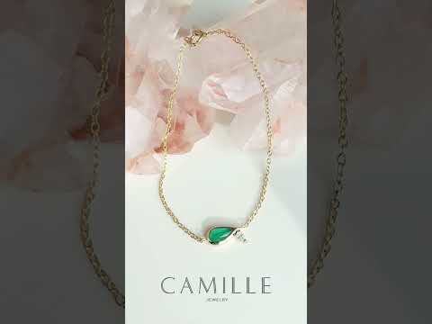Video of pear-shaped emerald and diamond bracelet in 14K gold by Camille Jewelry, showing dainty fine-jewelry sparkle and movement for layering or gifting.