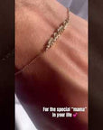 Model in video showing script mama bracelet in yellow gold color | Camille Jewelry