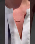 Video of Model wearing script mimi necklace on a delicate chain in yellow gold | Camille Jewelry