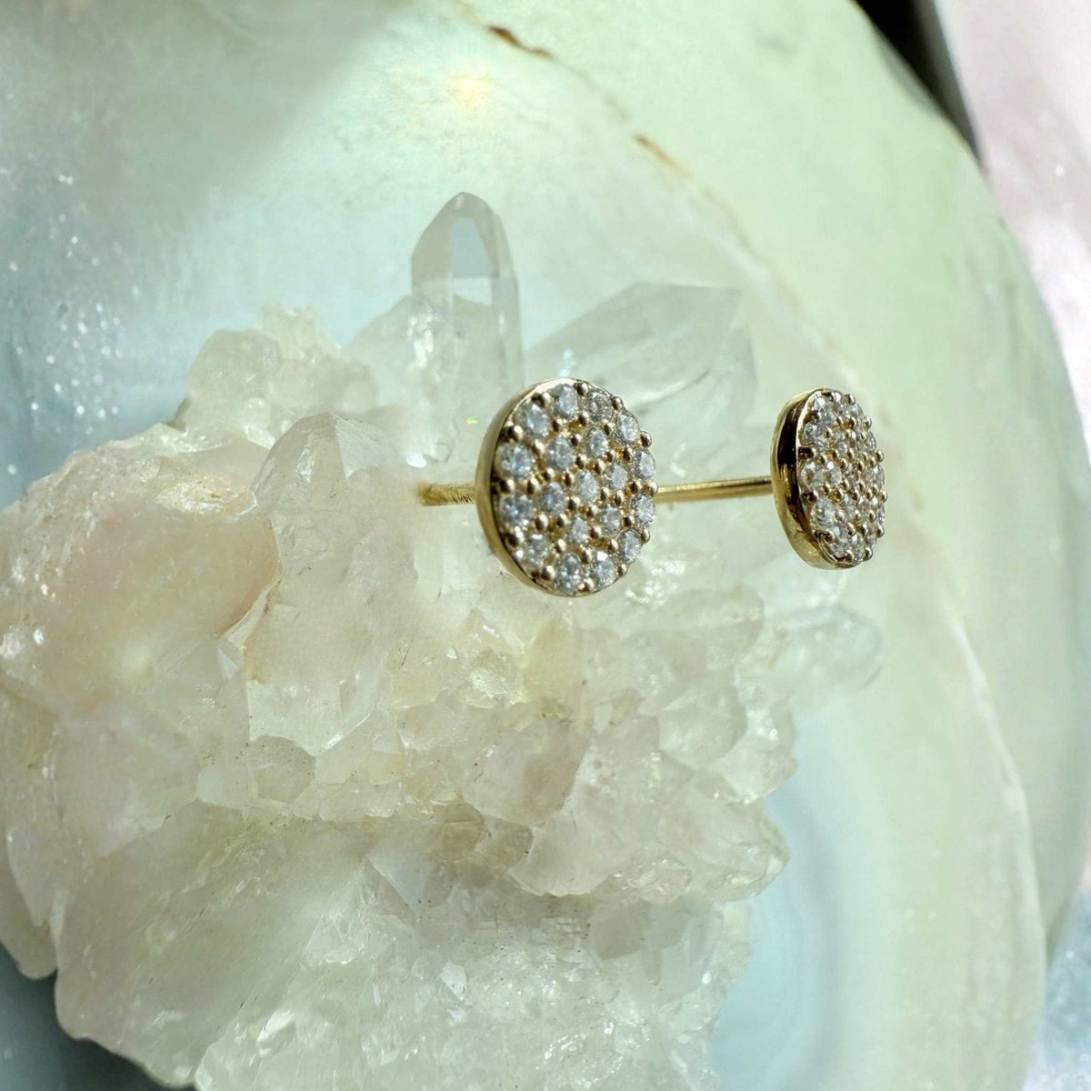 Pavé Diamond Stud Earrings in 14K yellow gold on a quartz stone display by Camille Jewelry