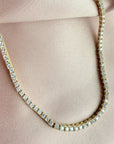 Close up of a tennis necklace with 2.5mm prong set cubic zirconia in gold plated sterling silver by Camille Jewelry