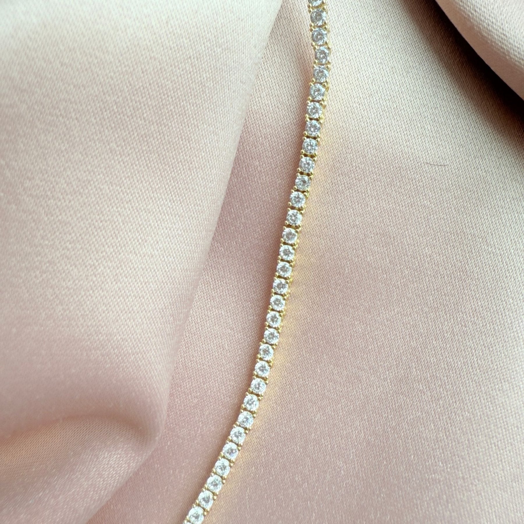 Close up of a tennis necklace with 2.5mm prong set cubic zirconia in gold plated sterling silver extreme by Camille Jewelry
close up