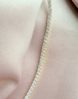 Close up of a tennis necklace with 2.5mm prong set cubic zirconia in gold plated sterling silver extreme by Camille Jewelry
close up