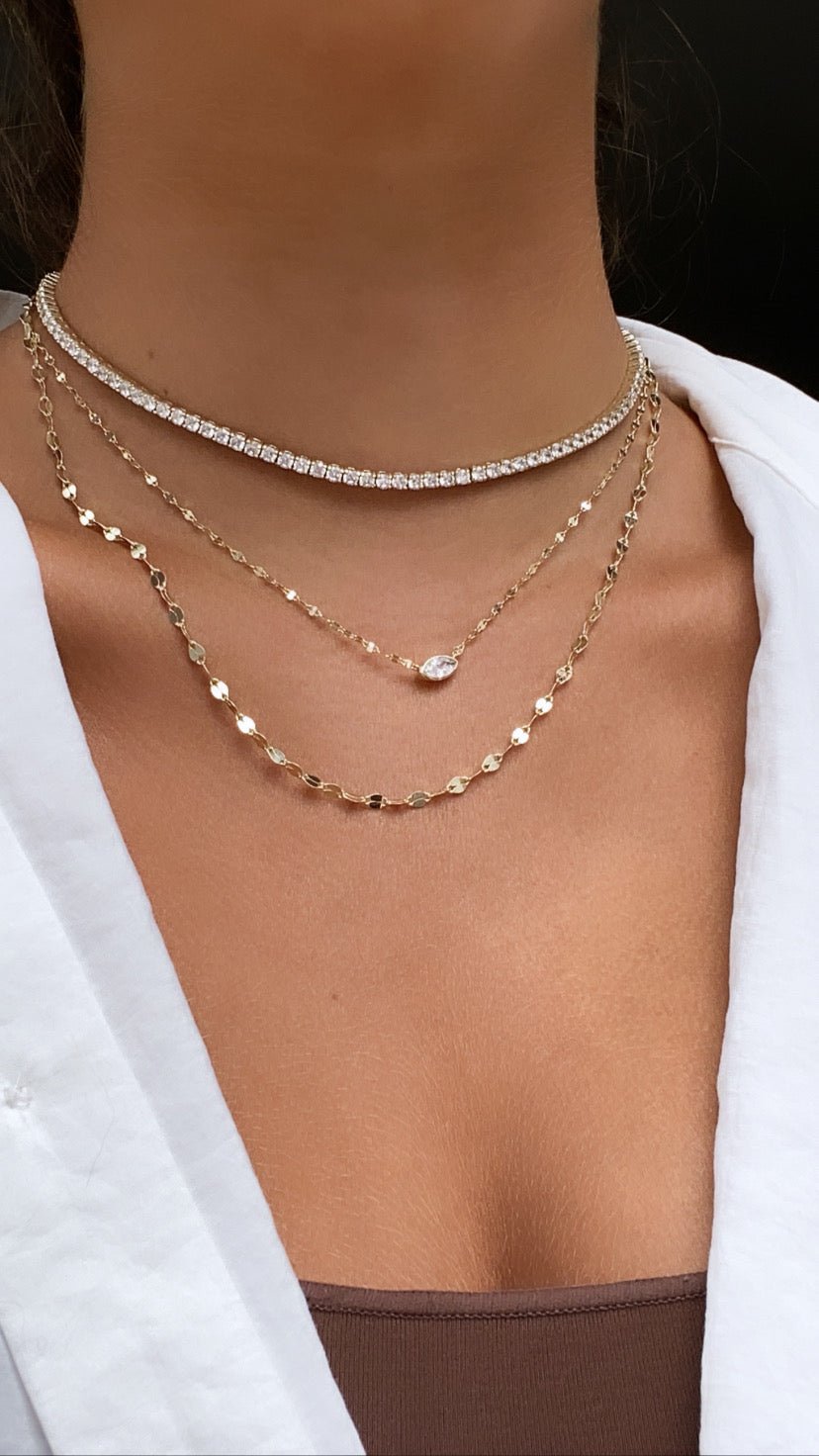 Woman wearing a modern tennis necklace in gold plated sterling silver by Camille Jewelry