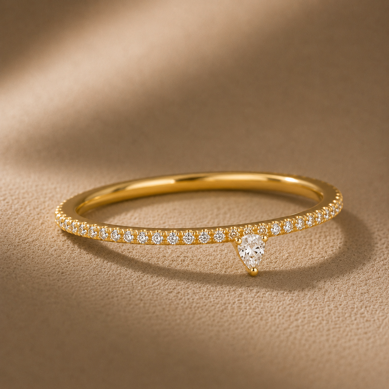 Close up of a trillion cut cubic zirconia stacking ring with pavé detailing in 18K gold vermeil by Camille Jewelry