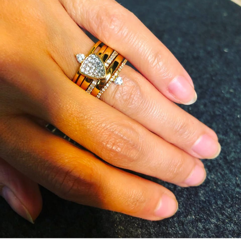 Woman wearing a skinny trillion pavé stacking ring in sterling silver on her hand by Camille Jewelry