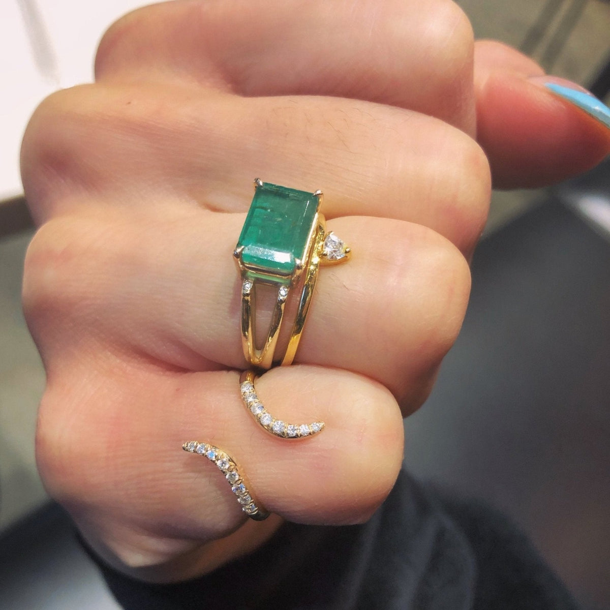 Skinny Trillion Ring – Dainty Women’s Jewelry in Gold Vermeil paired with other rings on a closed fist- Camille Jewelry