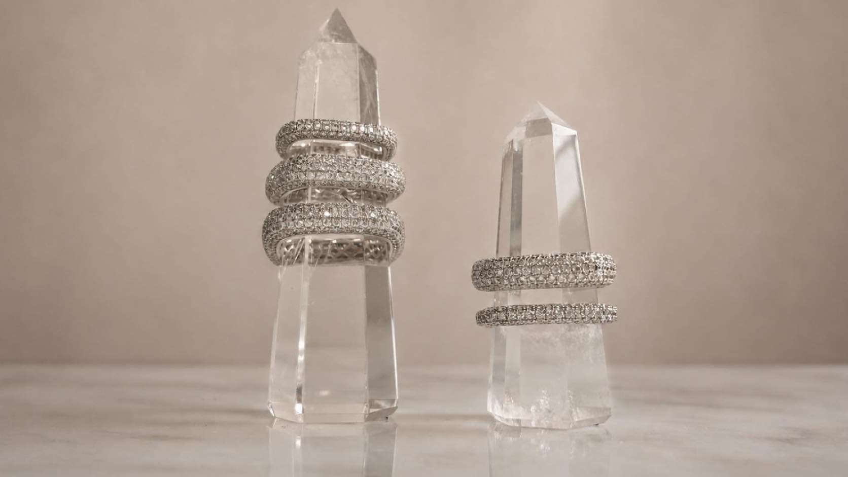 Sterling silver vermeil jewelry of soft square pave rings on a quartz display by Camille Jewelry