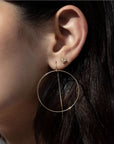 Woman wearing threader hoop earrings in 14K gold filled with hair pulled back by Camille Jewelry