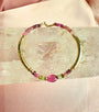 Tourmaline bracelet in 14K gold filled with graduated watermelon tourmaline rondelles and a smooth pink tourmaline center bead on a white background by Camille Jewelry