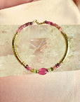 Tourmaline bracelet in 14K gold filled with graduated watermelon tourmaline rondelles and a smooth pink tourmaline center bead on a white background by Camille Jewelry