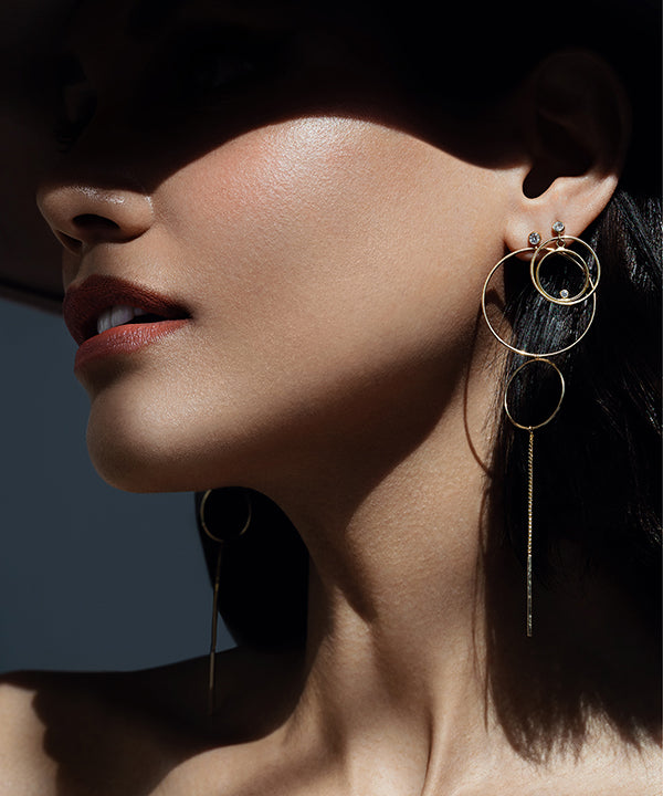 Woman wearing gold filled lightweight orbital hoop earrings | Camille Jewelry