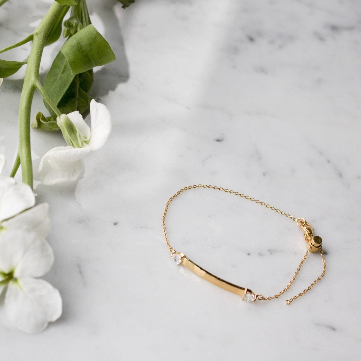 Gold Vermeil Women’s ID Bracelet on a marble display– Customizable Jewelry in Gold & Silver - Camille Jewelry